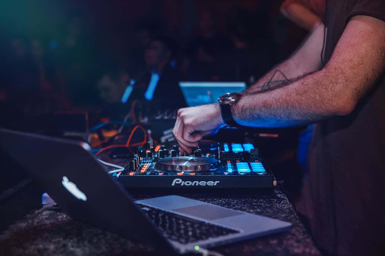 DJ performing with mixer in a vibrant nightclub setting. Perfect for entertainment and technology themes.